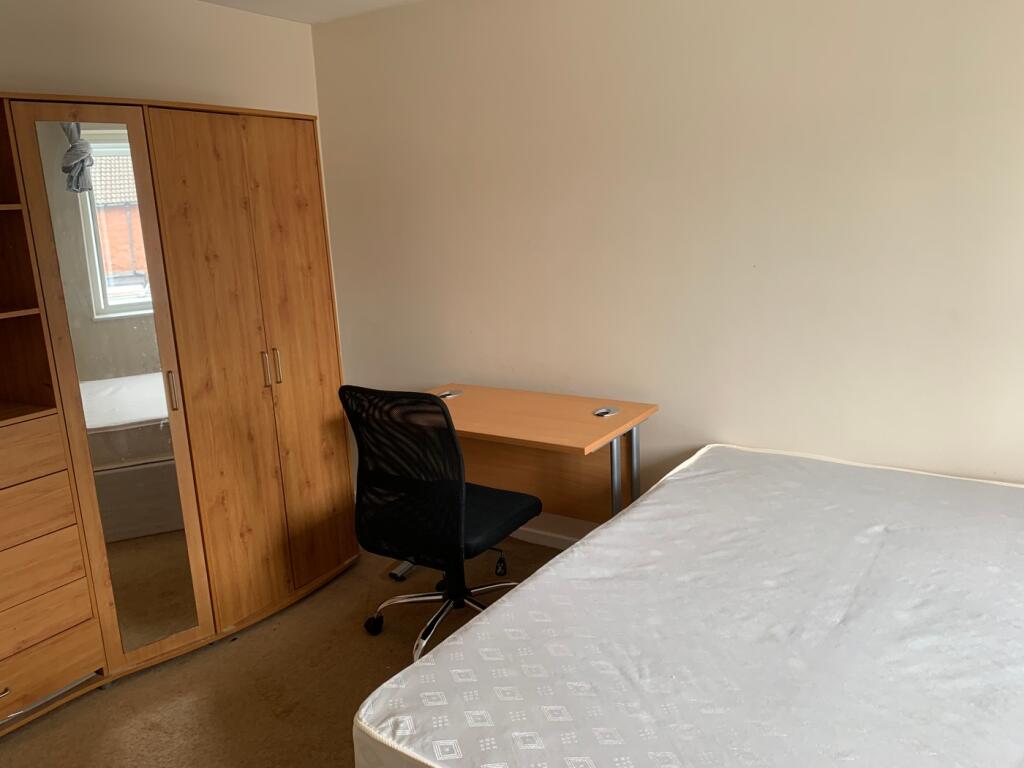A spacious and well-equipped double bedroom fea...