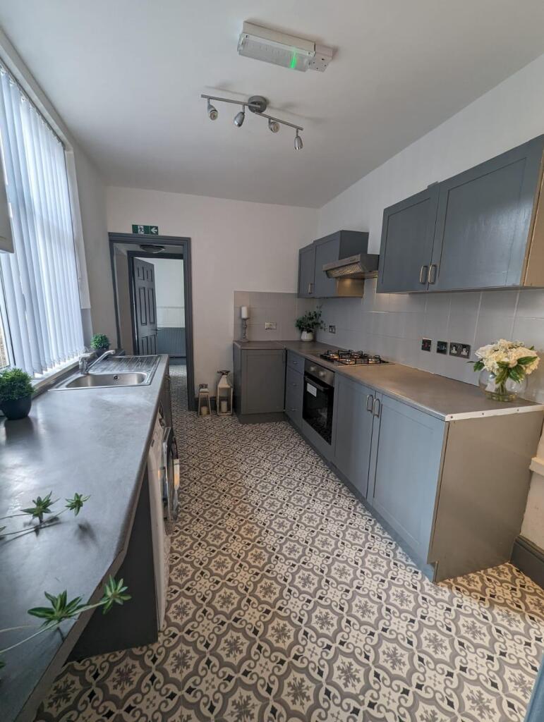 A bright and stylish kitchen featuring patterne...
