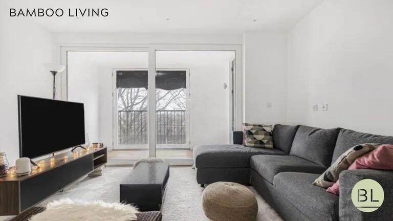 Bright and modern living room featuring a spaci...