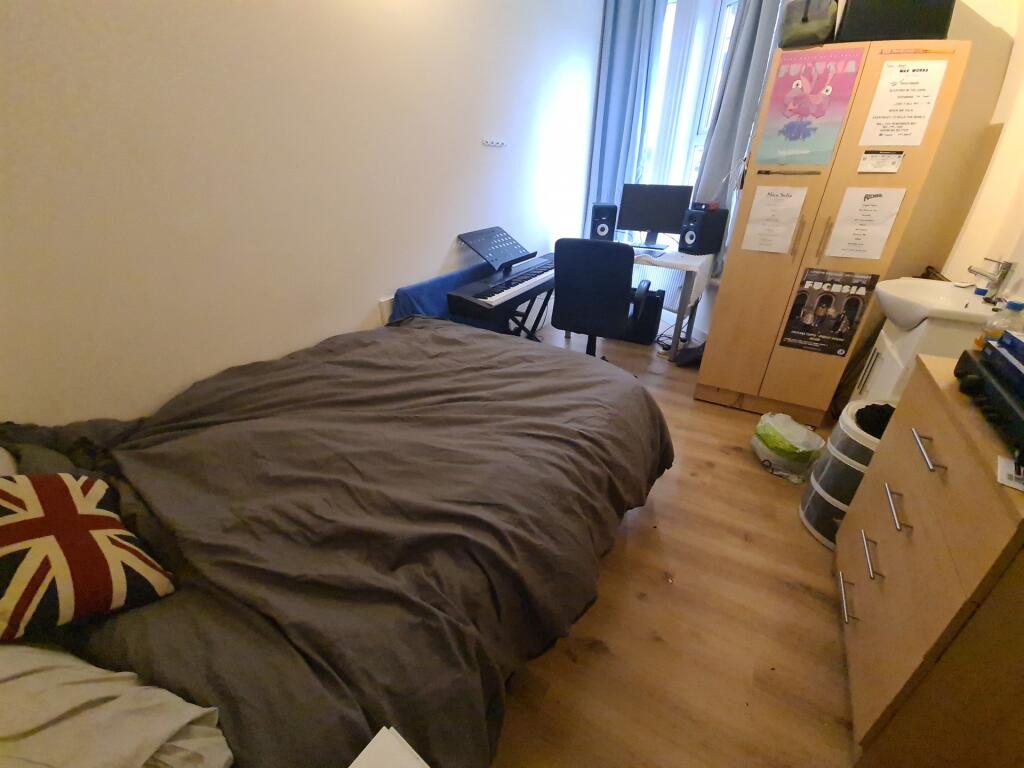 Cozy single bedroom featuring a comfortable bed...