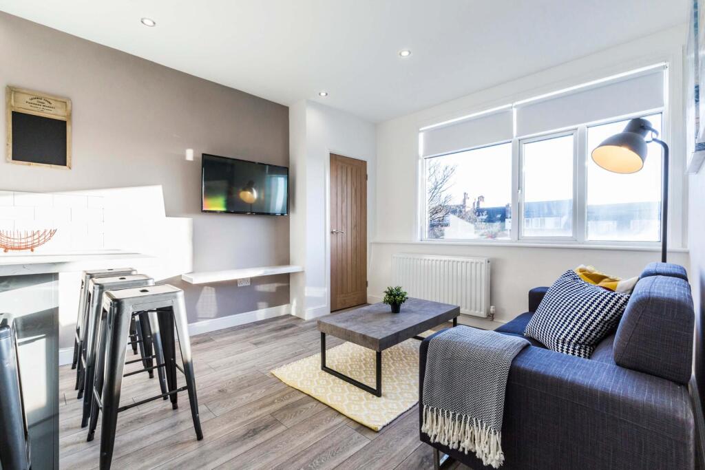 Bright, modern living area with a comfortable s...