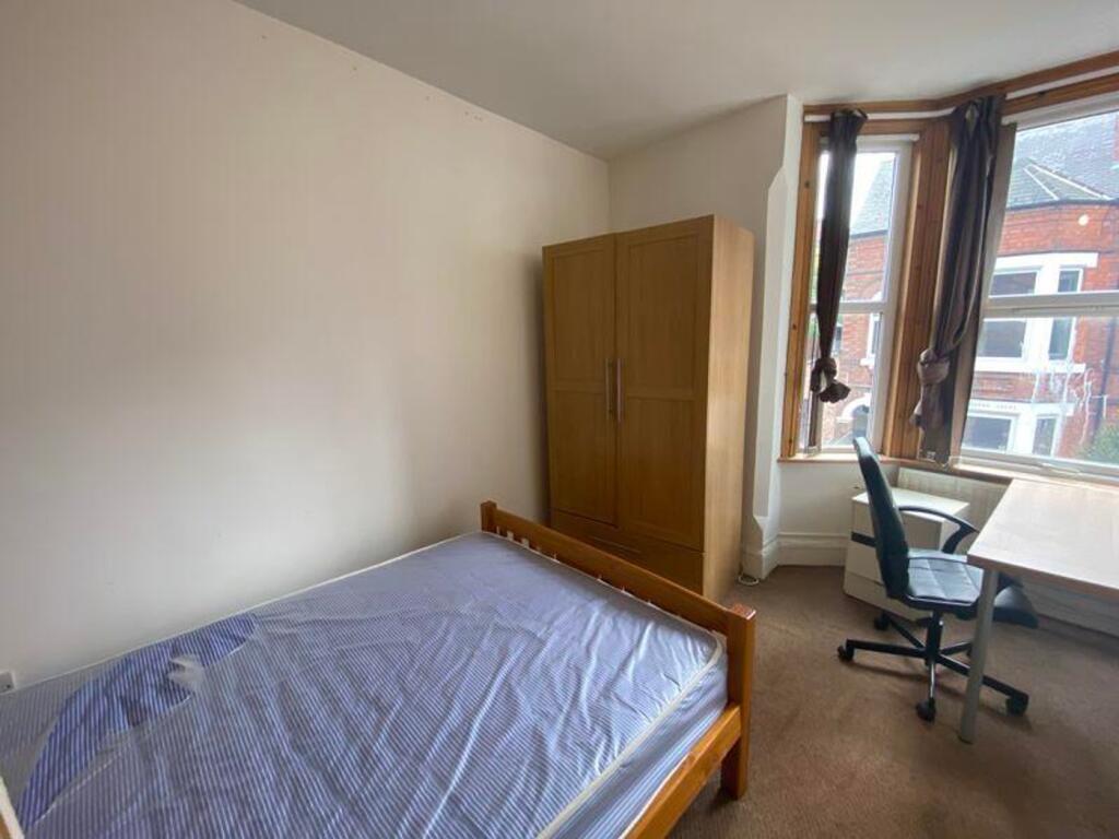 A bright and inviting double bedroom featuring ...