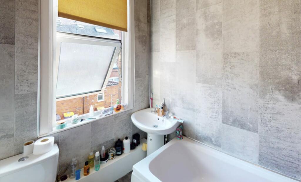 A well-maintained bathroom with a large window ...