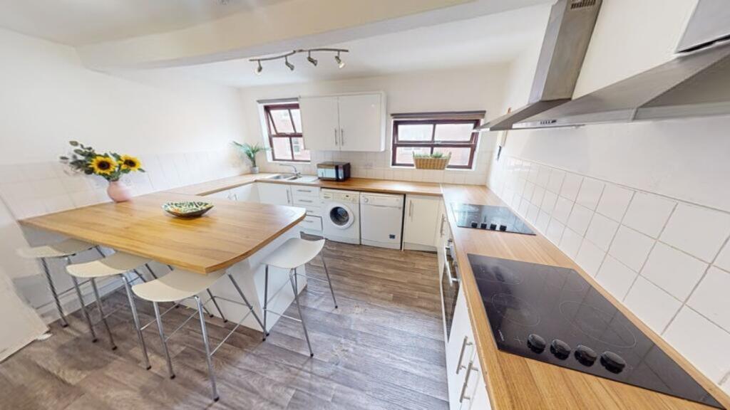 A bright and spacious kitchen with modern ameni...