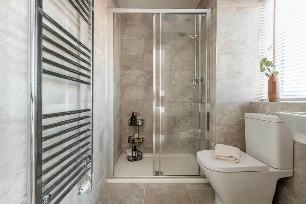 The main bedroom also hosts a private en-suite shower room