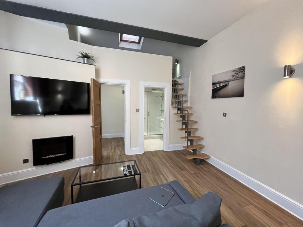 Modern and stylish living room featuring a wall...