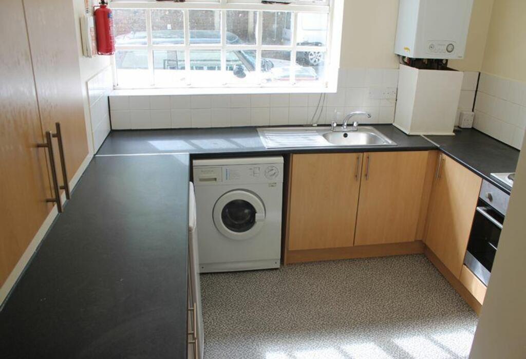 Spacious kitchen featuring modern appliances an...