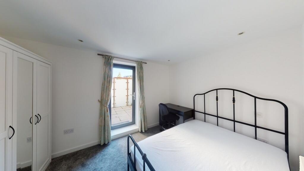Bright and tidy double bedroom featuring a stur...