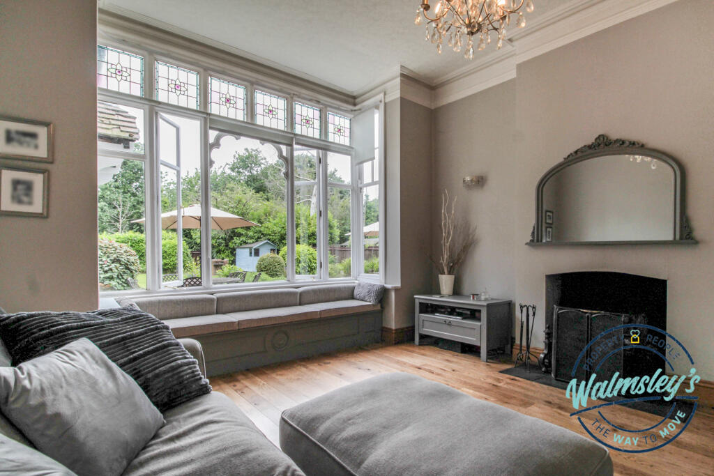 Stunning lounge with log burner in right wing