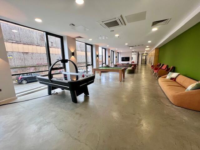 A spacious and modern communal lounge featuring...