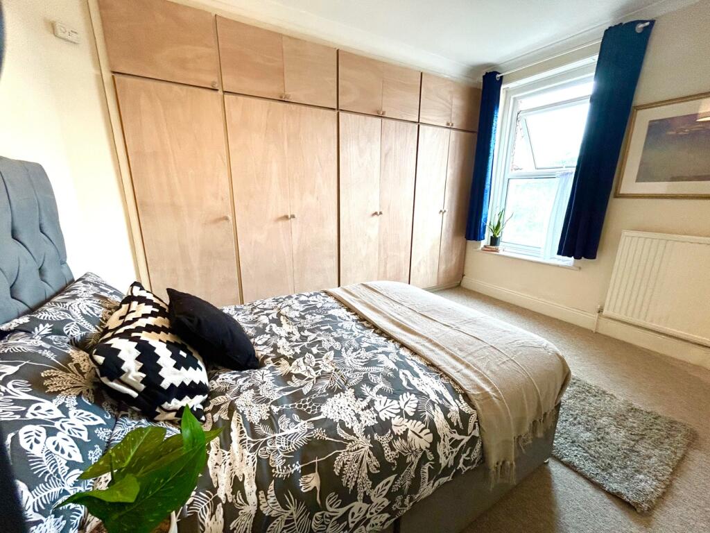 Spacious double bedroom featuring a comfortable...