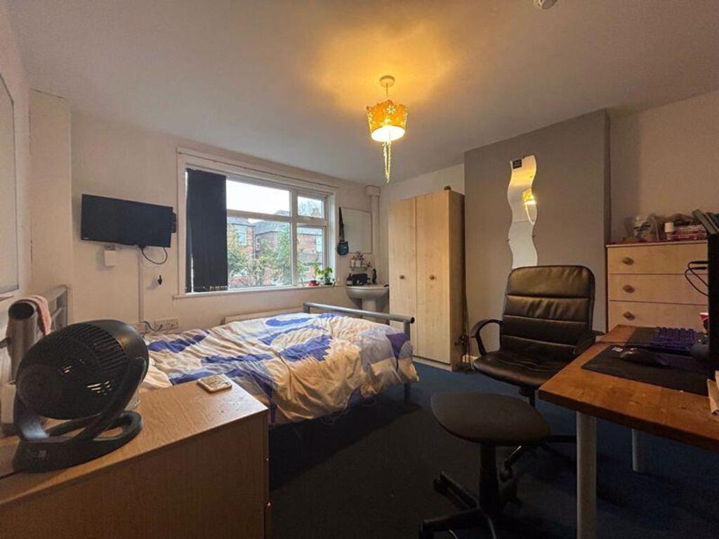 A spacious and inviting double bedroom with goo...