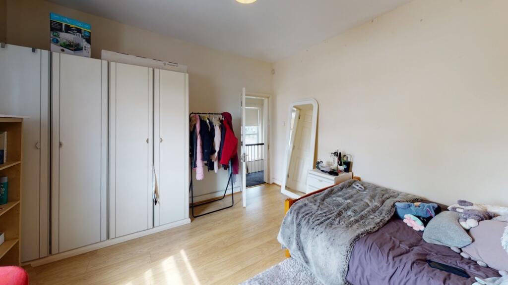 A bright and tidy double bedroom featuring ligh...