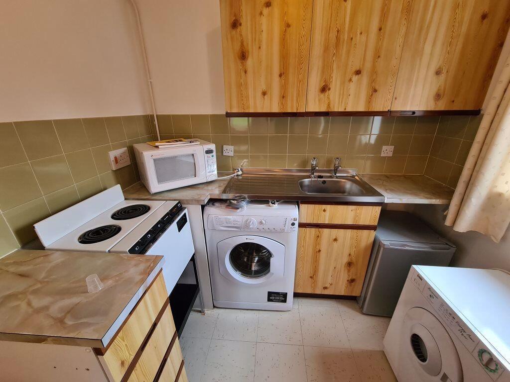 A compact kitchen featuring essential appliance...