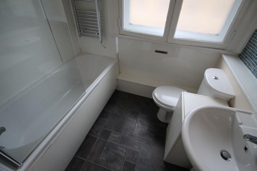 A clean and modern bathroom featuring a sleek d...