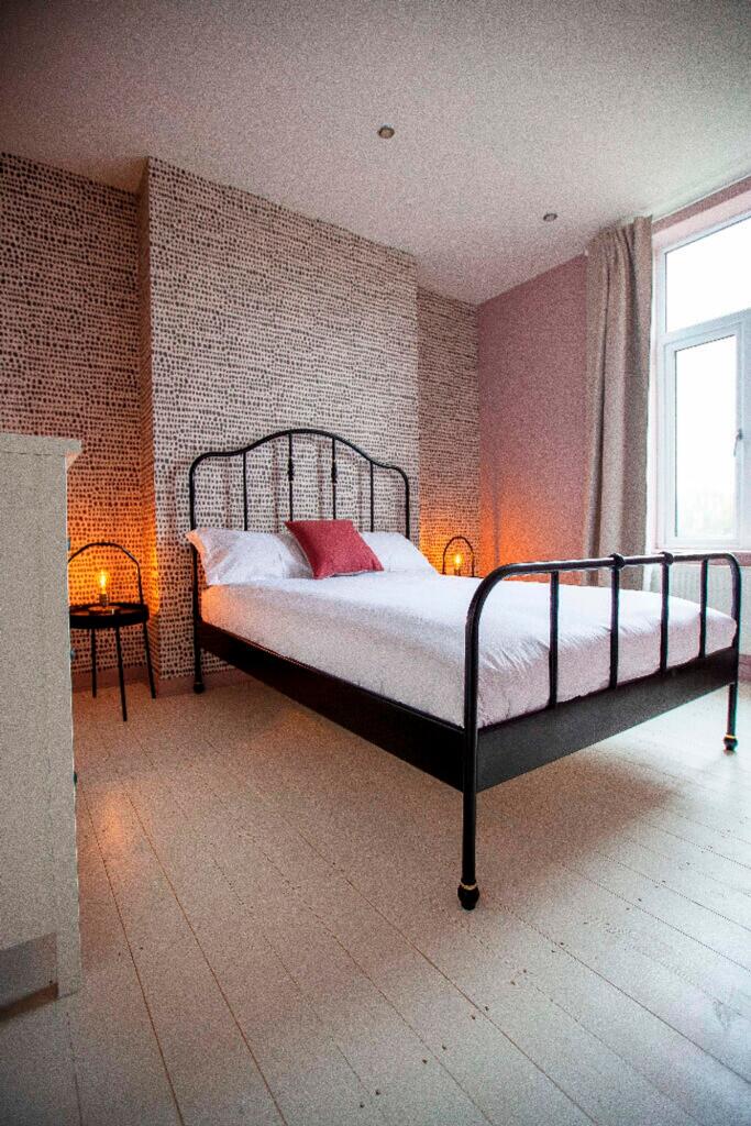 A stylish double bedroom featuring ample natura...