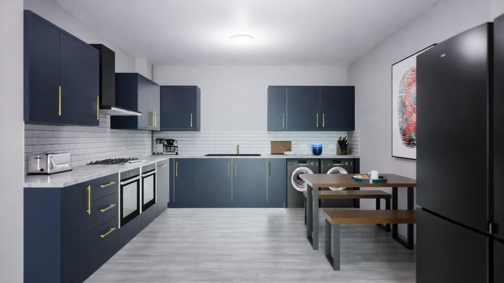 This modern kitchen features sleek cabinetry, a...