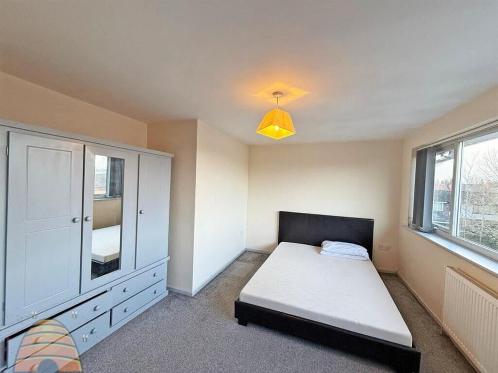 A bright and spacious double bedroom featuring ...