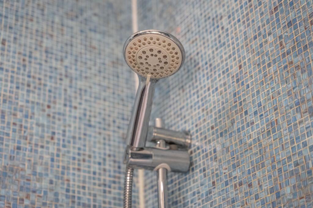 Close-up view of a modern chrome showerhead aga...