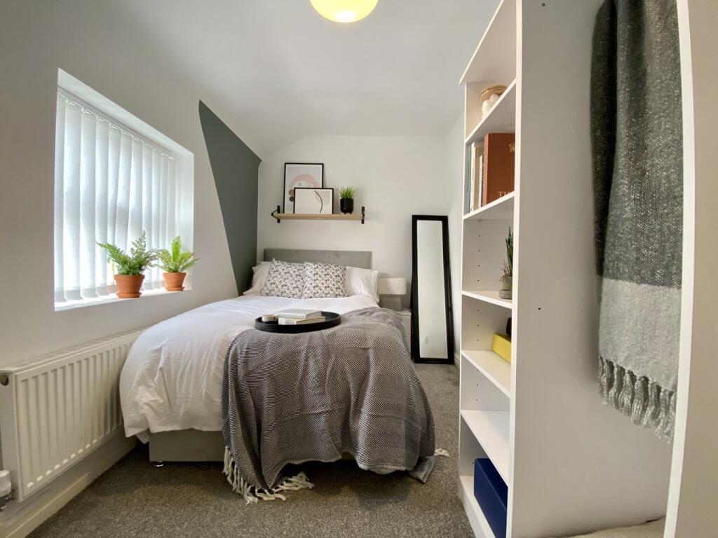 A bright and inviting double bedroom featuring ...