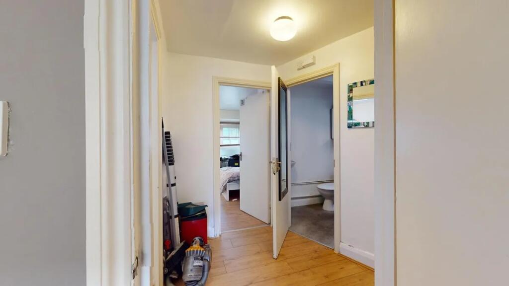 A bright and functional hallway with light wood...