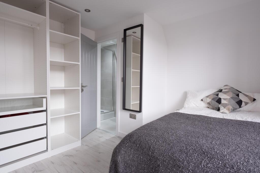 This charming double bedroom features a cozy la...