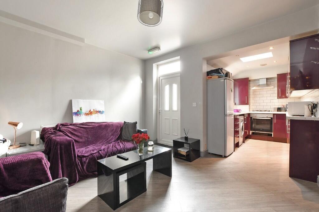 A cozy and well-maintained living room featurin...