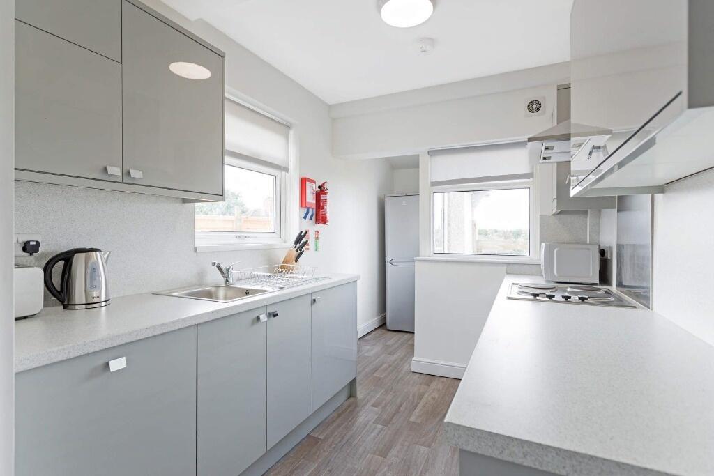 Bright and modern kitchen featuring sleek grey ...