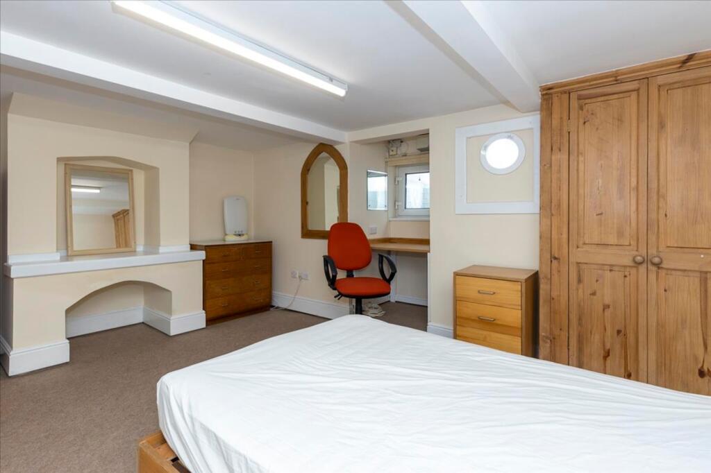 Spacious double bedroom featuring a comfortable...