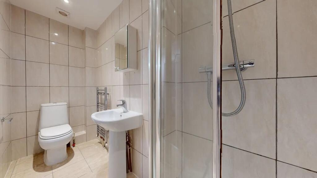 A modern bathroom featuring a clean white toile...