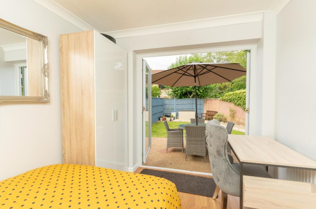 A bright and inviting double bedroom featuring ...