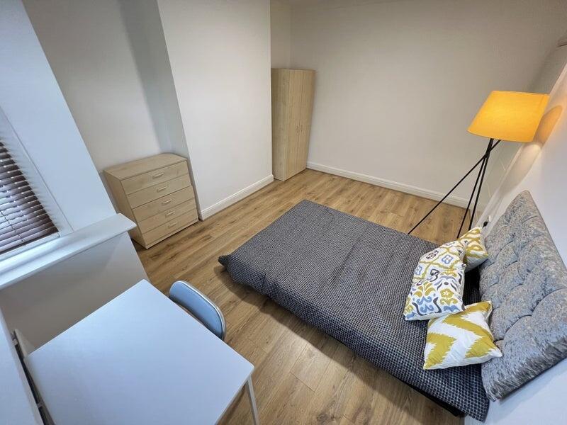 A cozy double bedroom featuring a comfortable d...