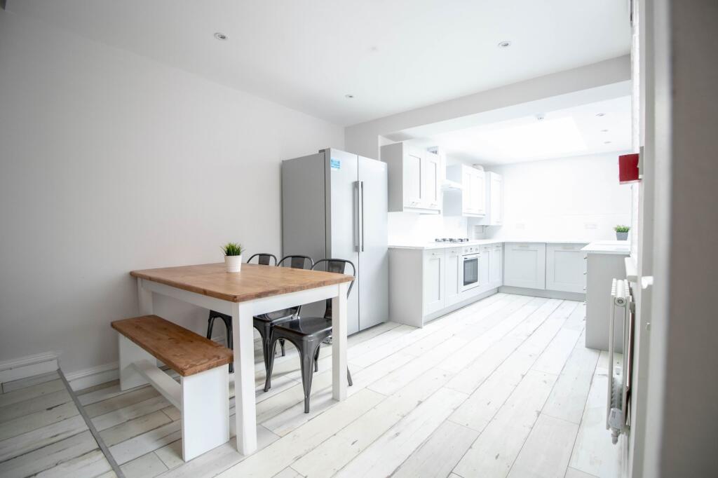 Bright and airy kitchen with ample natural ligh...