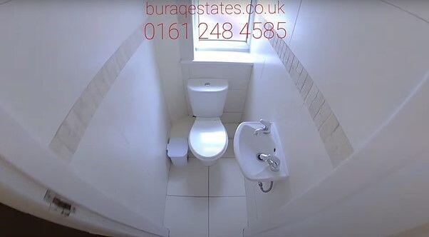 Bright, clean WC with modern white fixtures, ti...