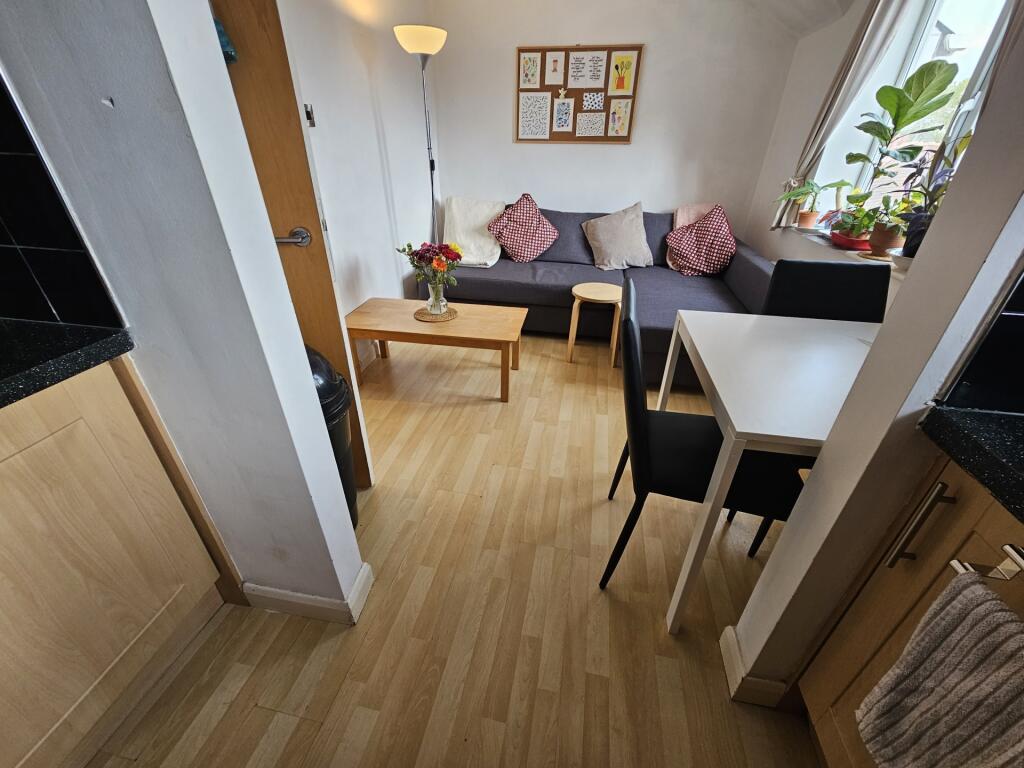 A cozy, well-maintained living room featuring c...