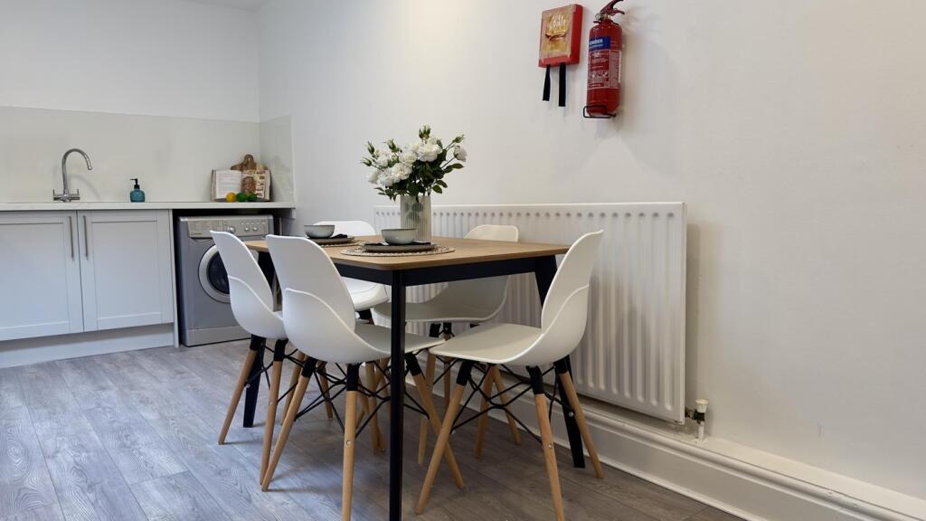 A bright and modern kitchenette with a stylish ...