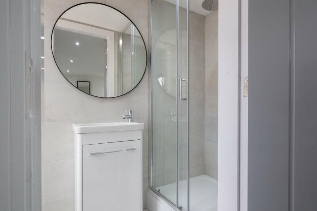 A modern bathroom featuring a sleek shower encl...