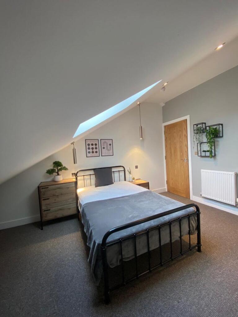 This charming double bedroom features a cozy la...