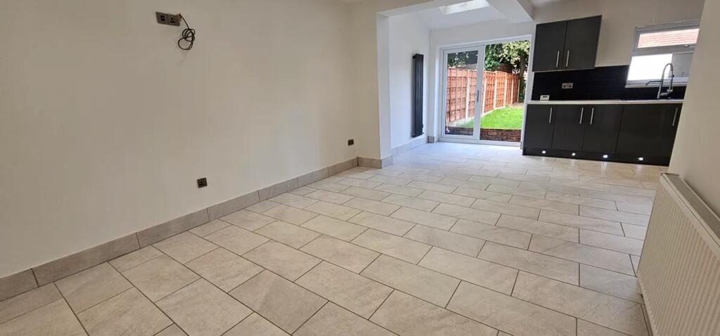 Modern kitchen featuring ample floor space, ele...