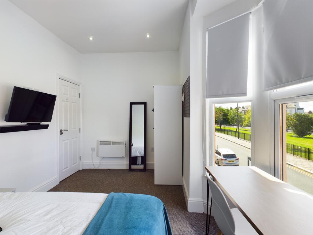 A bright and inviting double bedroom featuring ...