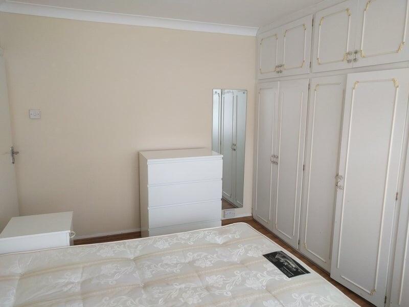 A bright double bedroom featuring clean white f...