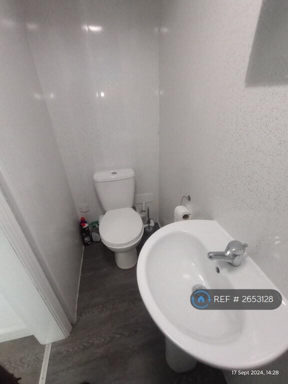 Toilet And Sink In Shower Room
