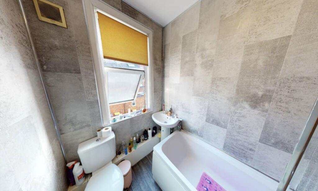 Bright and clean bathroom suite featuring a spa...