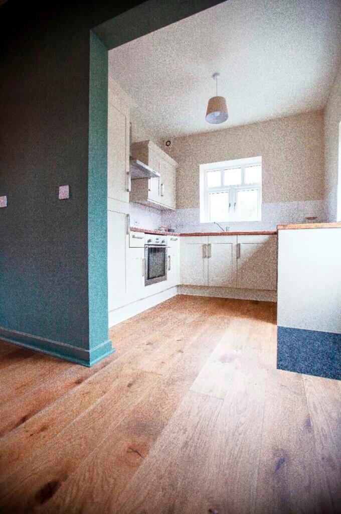 A bright and modern kitchenette with ample stor...