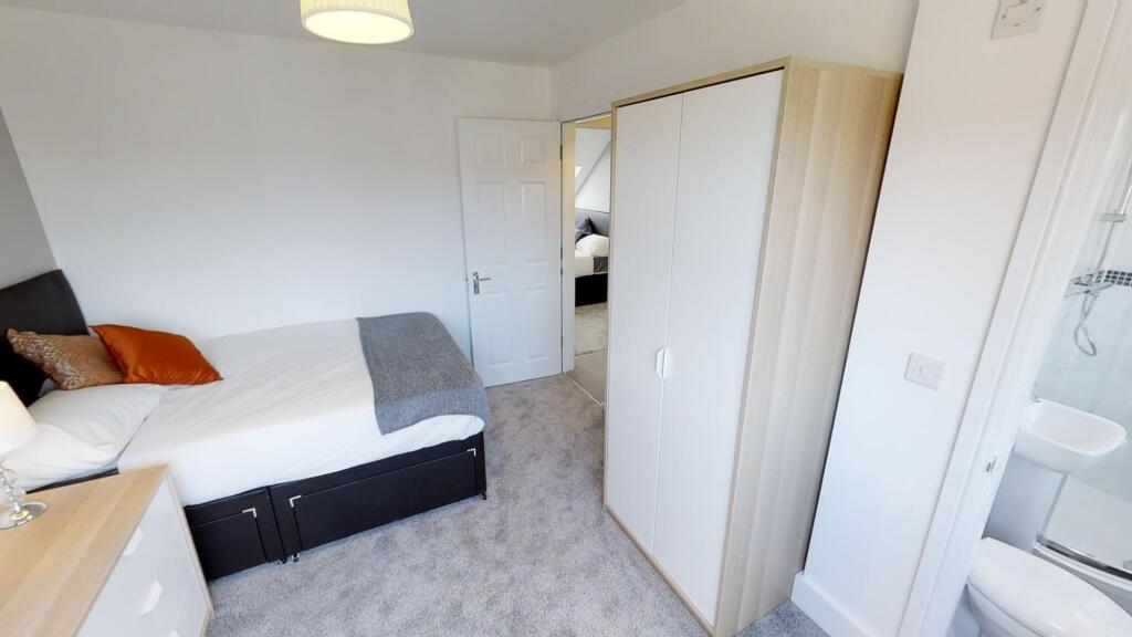 Bright and tidy double bedroom featuring a cozy...