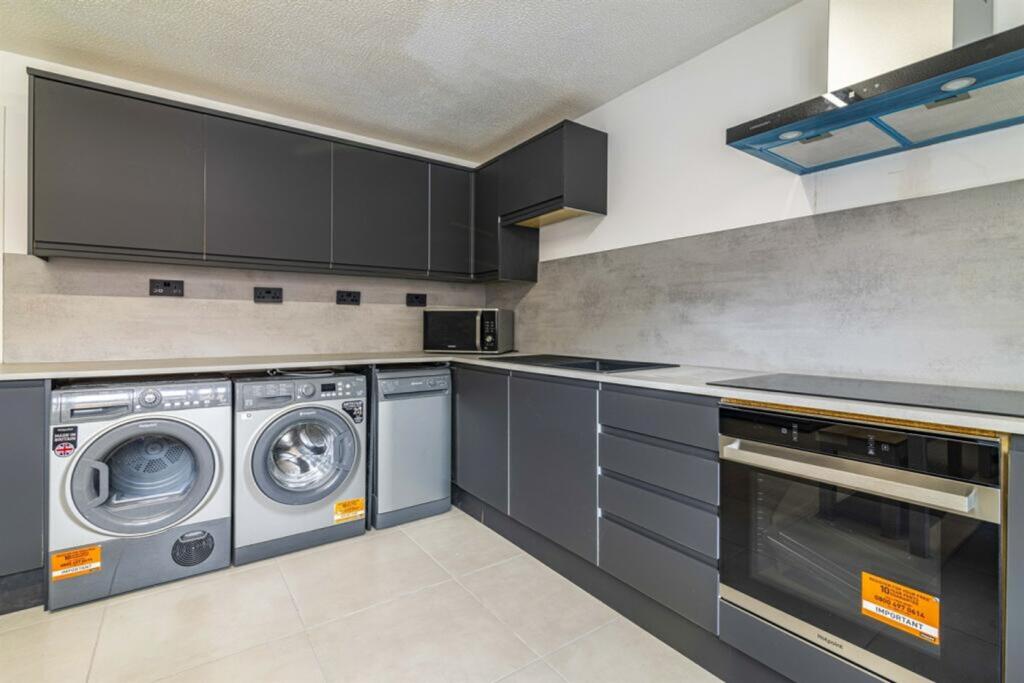 A modern and clean kitchenette equipped with al...