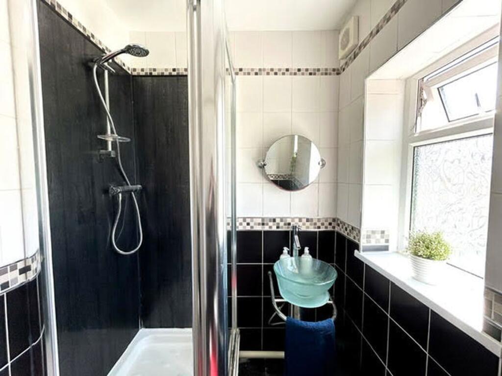 A modern bathroom featuring a stylish shower an...