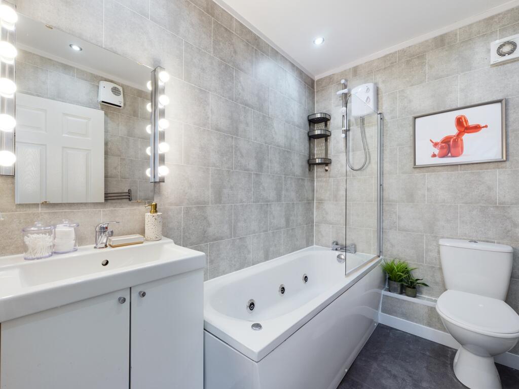 A spacious and modern bathroom featuring a luxu...
