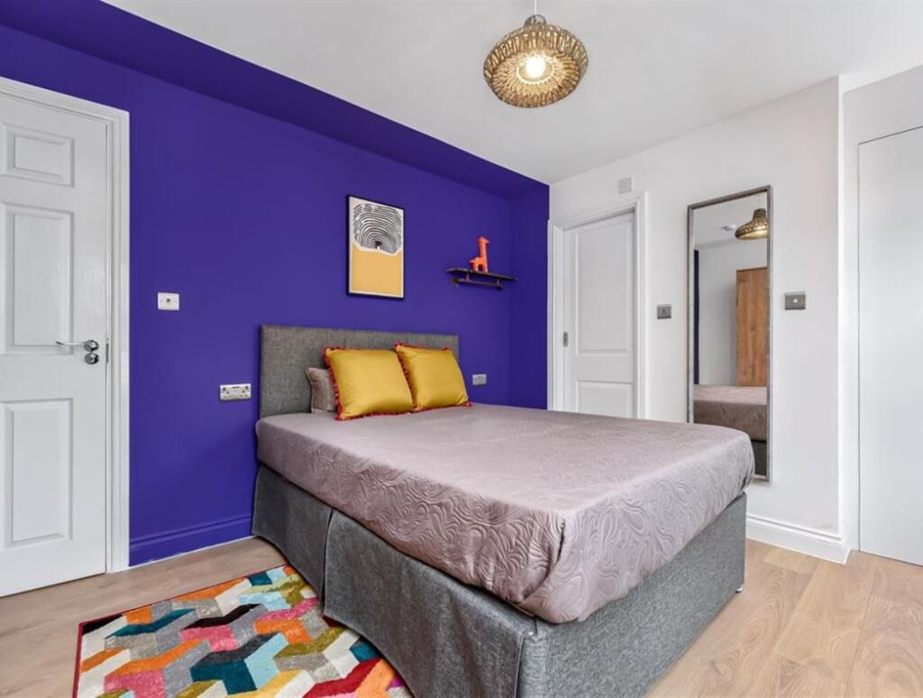 Bright and inviting double bedroom with a styli...