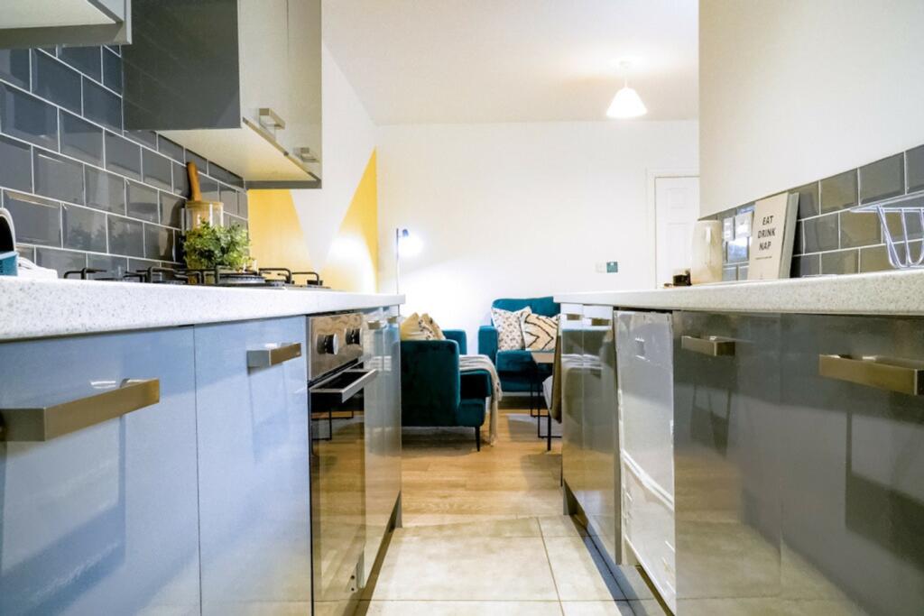 A modern and clean kitchenette that seamlessly ...